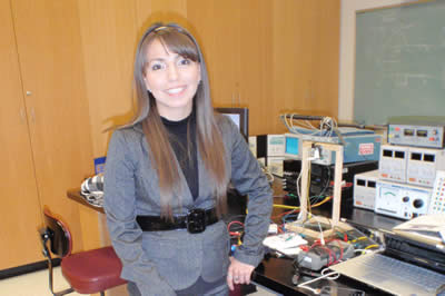 Laura V. in front of equipment
