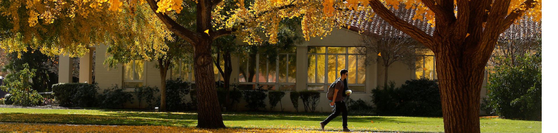student walking in front of the Thomas building