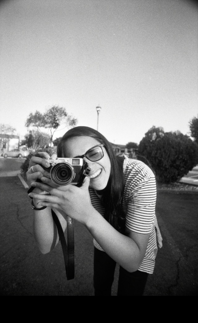 B/W photo of Simone holding a camera