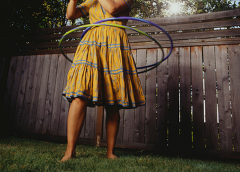 Person Wearing a Skirt and Hula Hooping