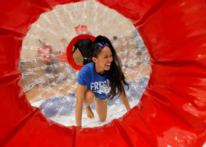 Female student in inflatable human hamster ball