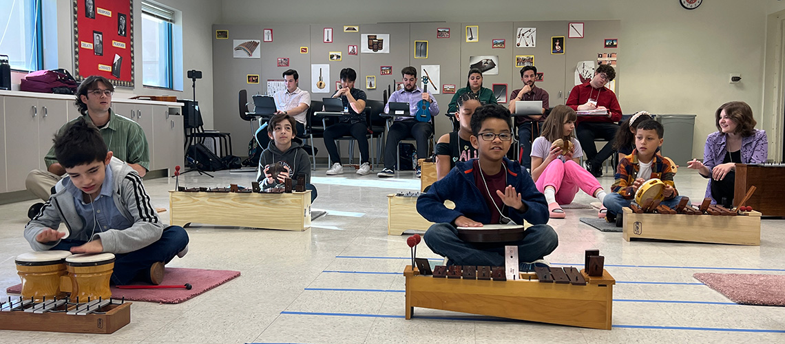 Fresno State Music Education students observe a classroom of children learning percussion instruments.